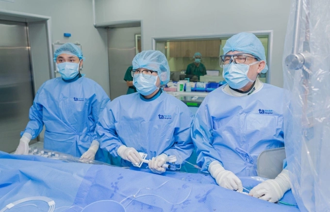 Giáo sư Nhân (bên phải) cùng êkíp can thiệp cho một người bệnh. Ảnh minh họa: Thanh Luận