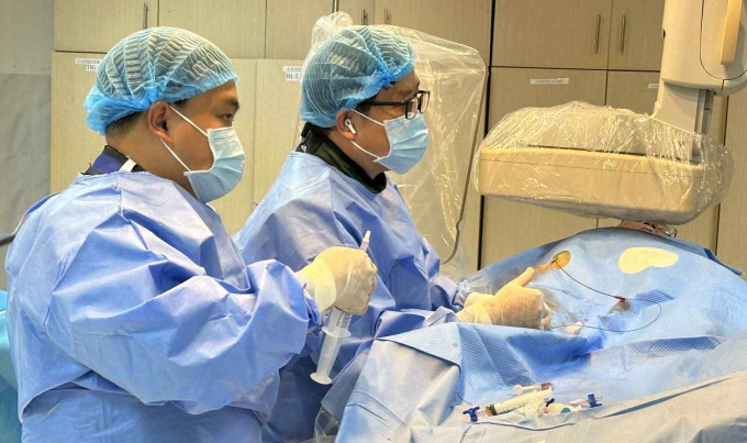 Bác sĩ Thiệu (bên trong) và đồng nghiệp trong phòng can thiệp. Ảnh: Bệnh viện cung cấp