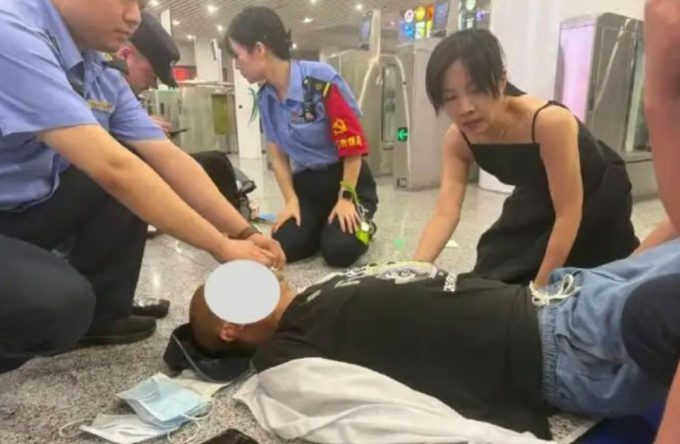 Li (váy đen) chạy đến sơ cứu một hành khách bất tỉnh ở ga tàu hôm 12/8. Ảnh: Douyin