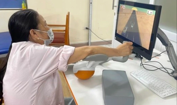Bệnh nhân đột quỵ vận động theo mô phỏng thực tế ảo tại Bệnh viện Bạch Mai. Ảnh:Bệnh viện cung cấp