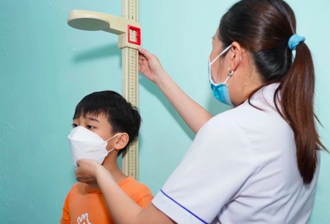 Một bệnh nhi đo chiều cao tại bệnh viện. Ảnh:Minh Thư