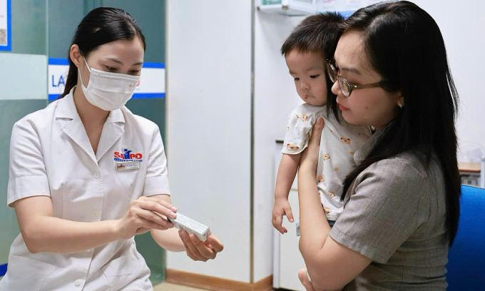 Trẻ đi tiêm phòng cúm mùa. Ảnh: Thi Ngân