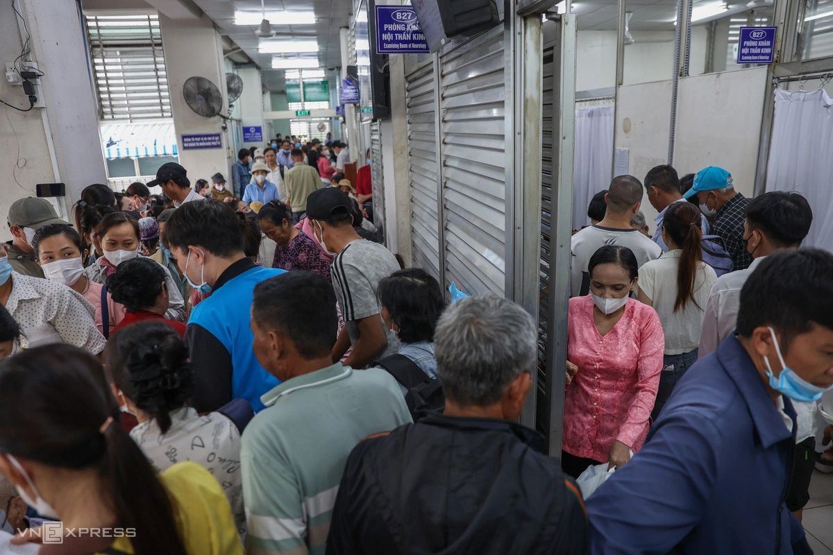 After clearing reception counters, patients move into the payment section, where rows of waiting chairs quickly fill to capacity.